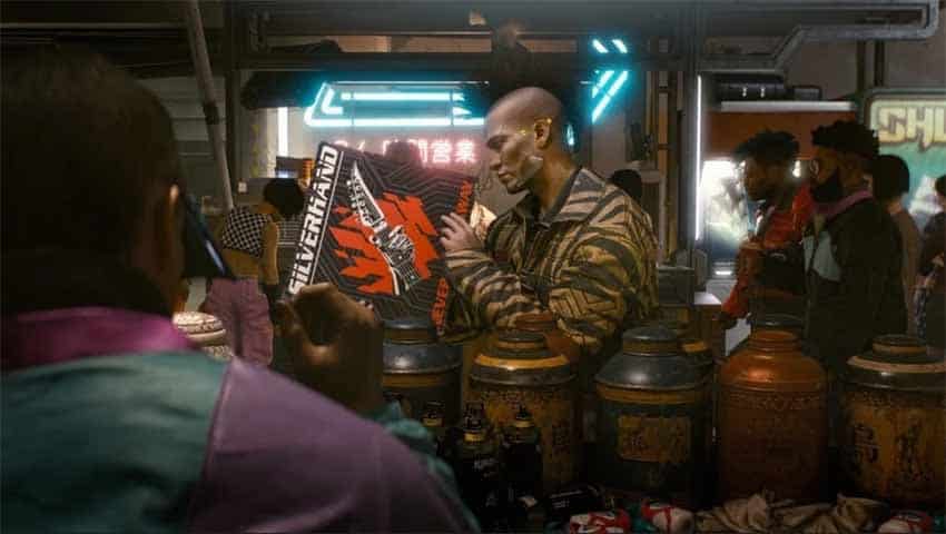 A screenshot showing an NPC holding a Johnny Silverhand record in Cyberpunk 2077