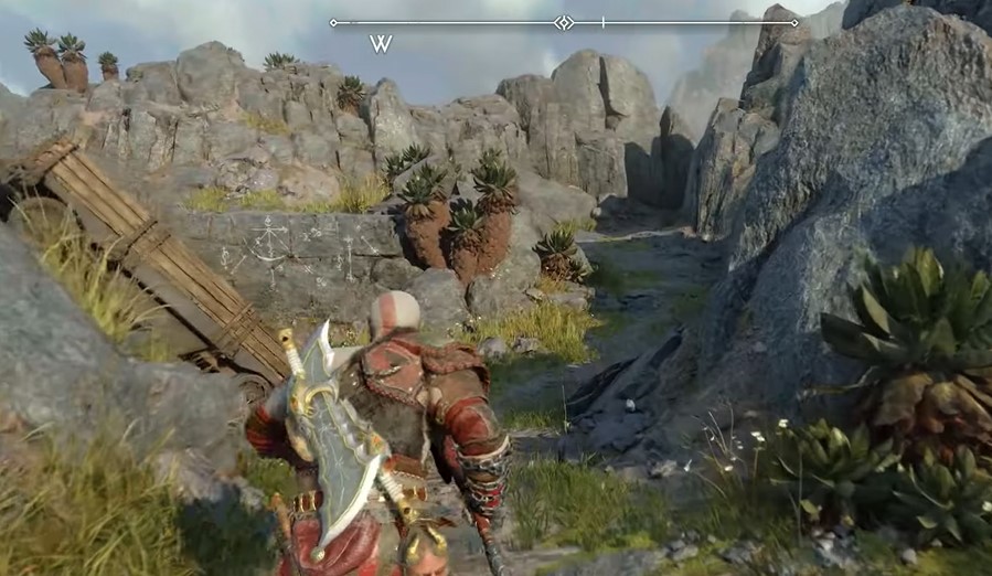 A screenshot of Kratos running through a ravine in God of War: Ragnarok