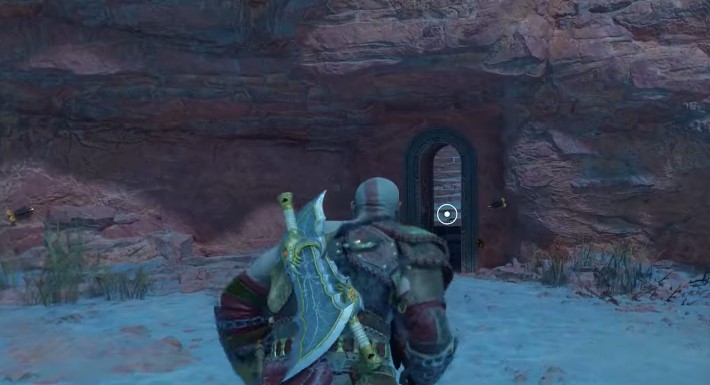 A screenshot showing Kratos running up to a doorway in God of War: Ragnarok