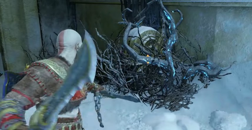 A screenshot of Kratos attacking some brambles in God of War: Ragnarok