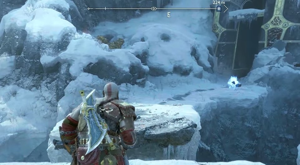 A screenshot of Kratos running up to a pair of frozen gates in God of War: Ragnarok