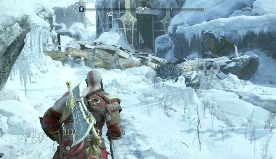 A screenshot of Kratos running up to a pair of frozen gates in God of War: Ragnarok