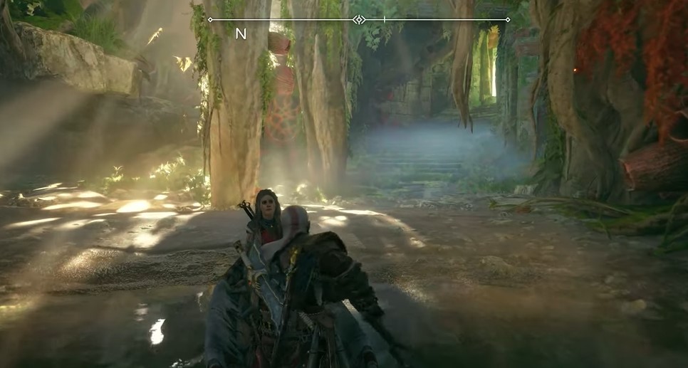 A screenshot showing Kratos riding a boat through a swamp in God of War: Ragnarok