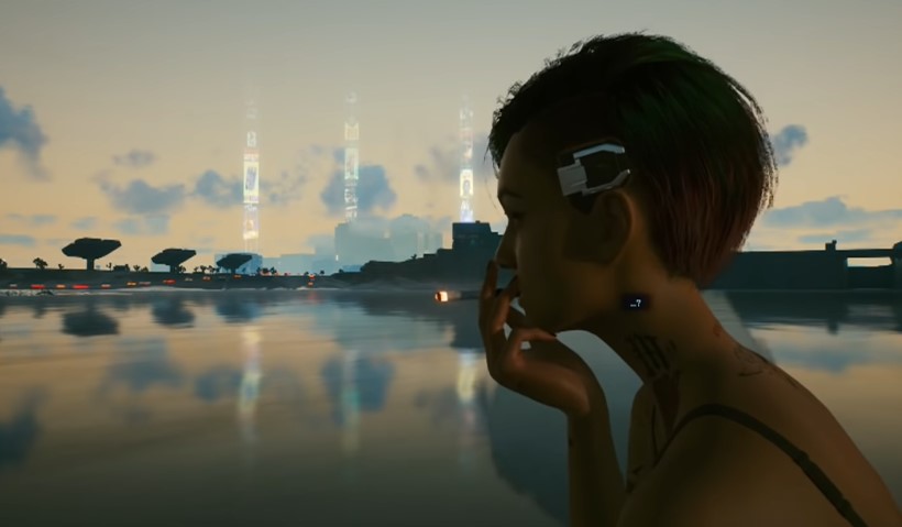 Judy smoking a cigarette with Night City in the background