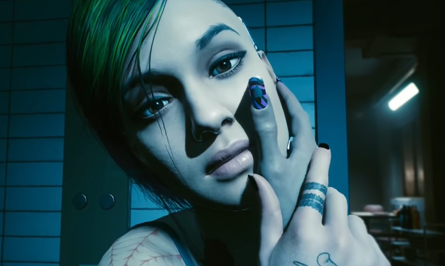 A screenshot of V placing her hand on Judy's face during their romance scene in Cyberpunk 2077