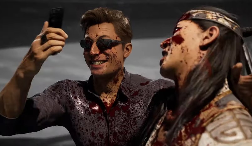 Johnny Cage taking a photo with a defeated opponent in Mortal Kombat 1