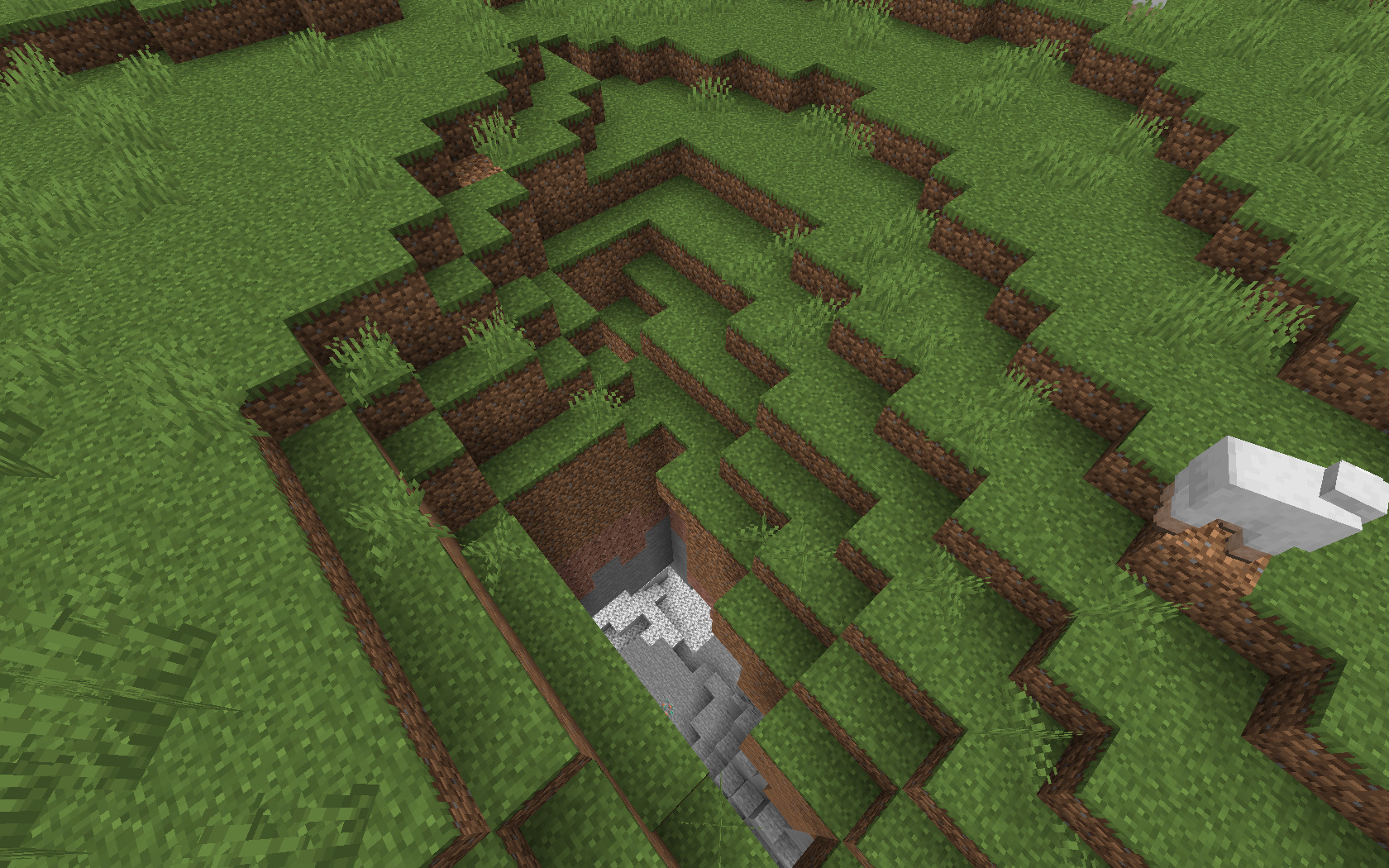 A screenshot showing a cave opening where you could possibly find a dungeon in Minecraft